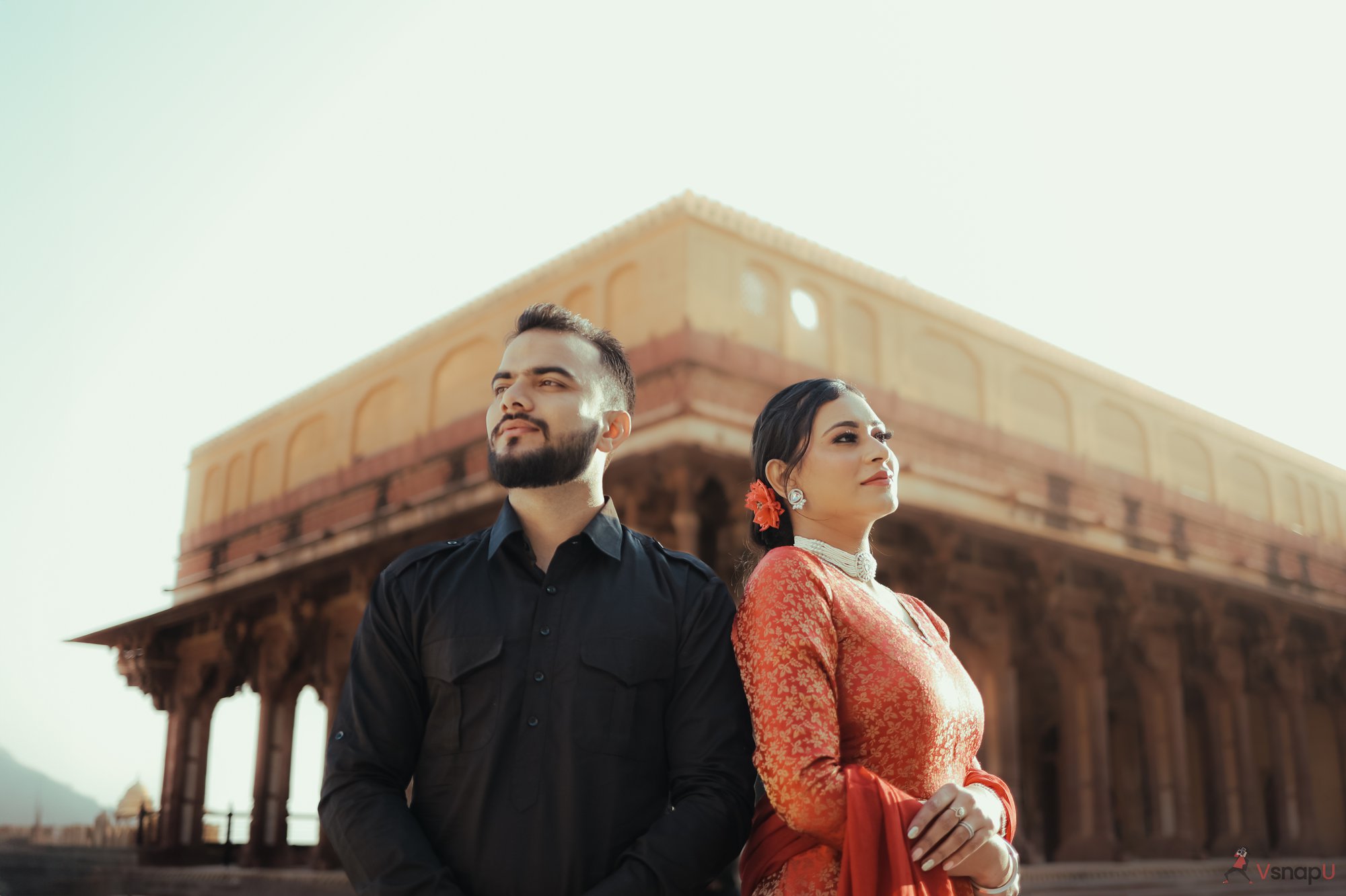 Timeless beauty—couple in ethnic wear standing in golden sunlight, embracing their pre-wedding moment.